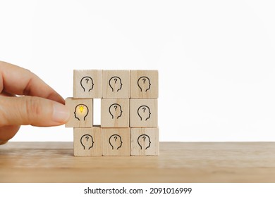 Senior's Hand Choose Bright Light Bulb In Human's Head Icon On Wooden Cube  For Creative Idea And Innovation , Outstanding, Leadership Concept