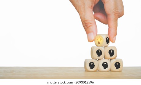 Senior's Hand Choose Bright Lightbulb Icon On Wooden Block ,the Top Of Stack, For Creative Idea And Innovation , Outstanding, Leadership Concept