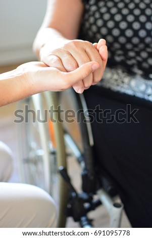 Seniors hand laying in a young hand