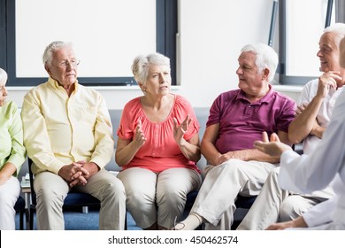 Seniors And Nurse Talking To Each Other In A Retirement Home