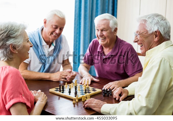 Seniors playing chess\
in a retirement home