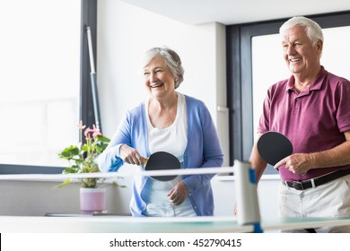 Seniors playing ping-pong in a retirement home - Powered by Shutterstock