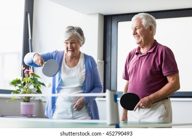 Seniors playing ping-pong in a retirement home - Powered by Shutterstock