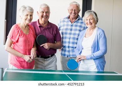 Seniors playing ping-pong in a retirement home - Powered by Shutterstock