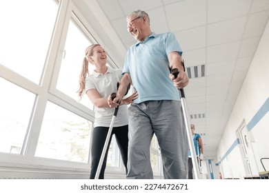 Seniors in rehabilitation learning how to walk with crutches - Powered by Shutterstock