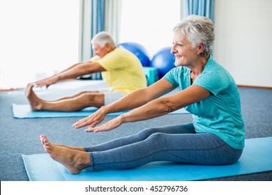 Seniors Stretching Legs In A Studio