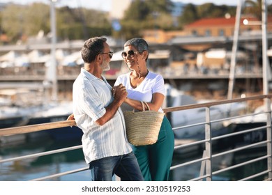 Seniors Summer Adventure. Happy Mature Spouses Embracing And Holding Hands At Marina Backdrop With Luxury Yachts and Sailboats. European Husband And Wife Anticipating Joyful Journey And Sea Cruise - Shutterstock ID 2310519253
