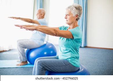 Seniors Using Exercise Ball In A Studio