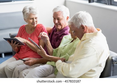 Seniors using tablets in a retirement home