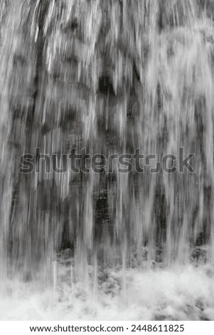 A sensational waterfall splashing water over the natural rocks and stones.