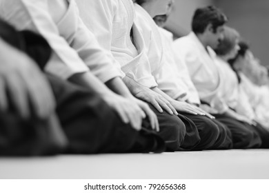 Sensei students sitting in a row on the mat at a seminar on aikido