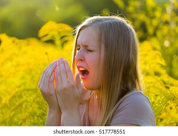 Sensitive blond woman sneezing, because of immune system  with allergy.