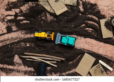 Sensory Play With Construction Trucks Toys, Dirt And Some Recyclable Materials