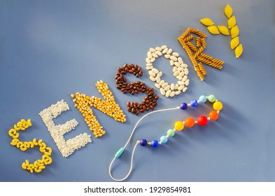 Sensory word written of rice, popcorn, beans, pasta. Sensory play for child at home. Activities Montessori, games for sensory processing disorder, child development and occupational therapy