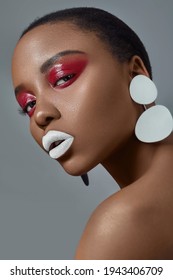 sensual african american dark skin woman looking at camera in red  eyeshadow and white lips