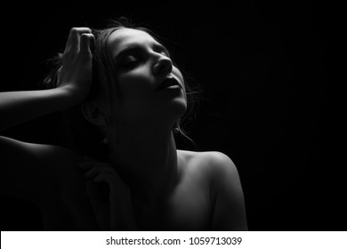 sensual aroused woman profile on black background with copy space monochrome