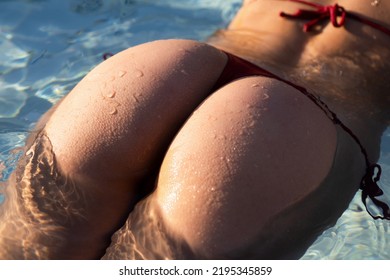 Sensual Ass In Swimming Pool Close Up, Summer Journey, Woman With Hot Natural Butt Relax In Water. Wet Body, Backside In Sexy Bikini. Seduction And Pleasure Model. Luxury Passion Buttocks.