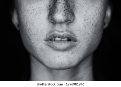 Sensual Beautiful Freckles Woman Mouth Close Up Image Against Black Background. Black And White Image.