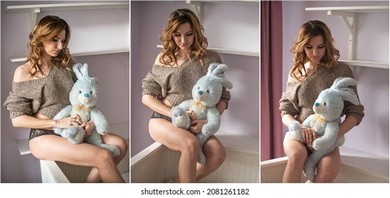 Sensual Girl In Black Bikini With A Plush Bunny Blue In His Arms.The Beautiful Woman With A Blue Plush  Rabbit. Indoor Scene With Attractive Lady With Plush Toy