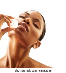 Sensual Latin Woman Putting An Ice Cube On Her Face. Woman Touching An Ice Cube,