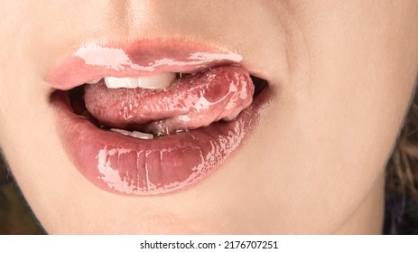 Sensual Pleasure, Passion And Flirting Photo Illustration - Unrecognizable Young Female Touching Her Moist Plump Lips With Her Tongue Closeup With Shiny Reflections