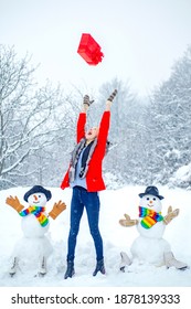 Sensual Winter Girl Posing And Having Fun. Happy Girl Portrait. Christmas Winter Poeple. Beauty Winter Woman With Snowman In Frosty Winter Park