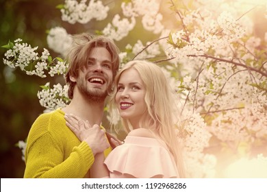 Sensual Woman And Man In Cherry Bloom. Couple In Love In Blossoming Flower, Spring. Love And Romance, Relationship, Happy Couple. Man And Woman In Spring, Easter. Spring, Nature, Environment. Family