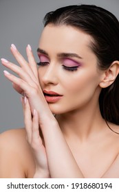 sensual woman with pink eye shadows isolated on grey