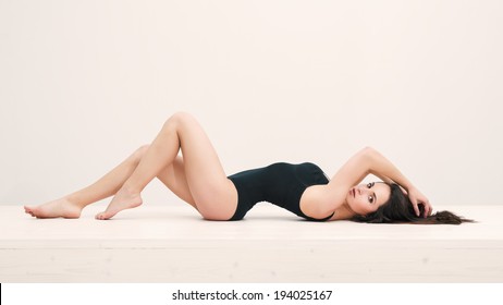 Sensual Woman Portrait Laying On Table With Black Underwear. Full Body Portrait. 