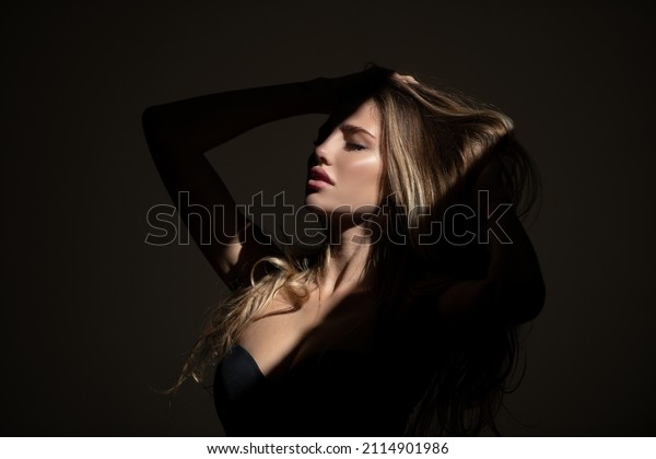 Sensual woman with shadows on beautiful face.\
Sensual girl with art shadow\
light.