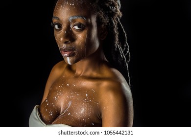 Sensual Young African American Woman With Spilled Milk On Face Looking At Camera Isolated On Black