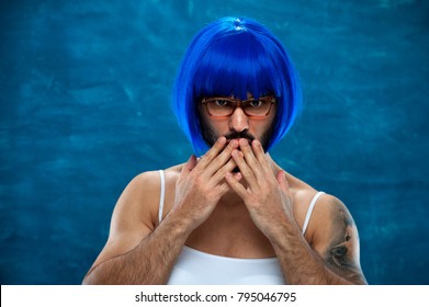 Sensual Young Male Cross Dressing Person Wearing Blue Wig And Female Cloth Holding His Fingers On Lips