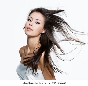 Sensual young woman with beautiful long brown hairs, posing isolated on white