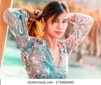 Sensuality Beautiful Asian Woman Is With Pony Tail Hair Tight Up Receiving Sunlight On The Beach Side For Vacation And Relaxation Cocnept.