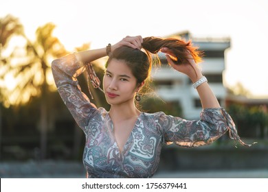 Sensuality Beautiful Asian Woman Is With Pony Tail Hair Tight Up Receiving Sunlight On The Beach Side For Vacation And Relaxation Cocnept.