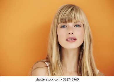 Sensuous Blond Woman On Orange Background