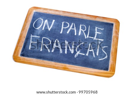 sentence french is spoken written in french on a chalkboard