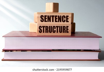 SENTENCE STRUCTURE - Words On Wooden Blocks On The Background Of Books. Info Concept