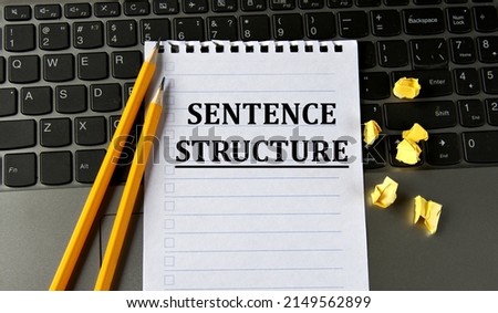 SENTENCE STRUCTURE - words in a white notepad on the background of a laptop with pencils. Business concept