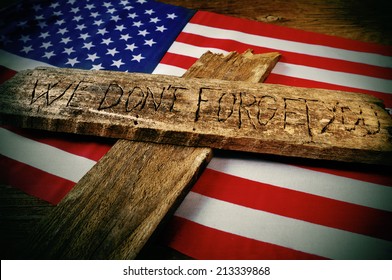 the sentence we do not forget you carved on a wooden cross over the flag of the United States