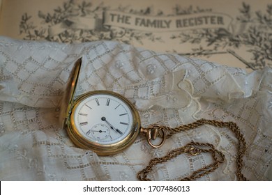 Sentimental photo of family items in times past with a family register, handkerchief and pocket watch. - Shutterstock ID 1707486013