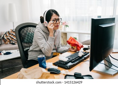 Sentimental Woman Crying And Wiping Tears With Napkin While Watching Dramatic Film Movie. Lazy Female Homebody At Home Binge Watch Series On Computer In Messy Room Eating Unhealthy Junk Food Chips