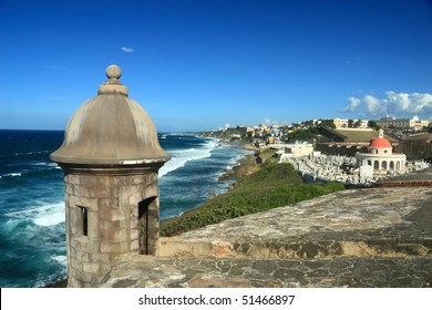 Sentry box overlooking the Atlantic Ocean at 'El Morro' (Castillo San Felipe del Morro) and the La Perla district of Old San Juan, Puerto Rico, including an old cemetery
