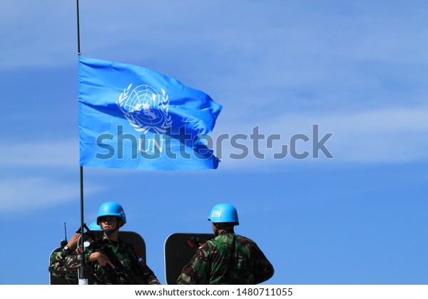 Sentul, West Java,\
Indonesia - May 18th, 2011: Indonesia\'s UN Peacekeeper with UN flag\
on the left side
