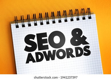 Seo and Adwords text on notepad, business concept background