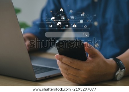 SEO Concept. Businessmen use smartphones with laptops. SEO icon for analysis SEO Search Engine optimizing your website to rank in search engines or SEO. best promoting ranking traffic on your website. Foto d'archivio © 