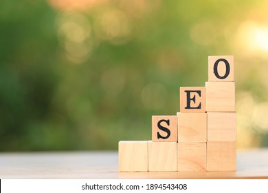 SEO, intial work of Search engine optimization is the process of improving the quality and quantity of website traffic on wooden block with green bokeh nature. Business strategy concept. - Shutterstock ID 1894543408