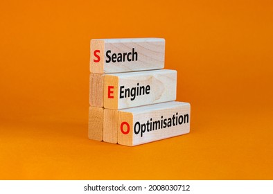 SEO search engine optimisation symbol. Wooden blocks with words 'SEO search engine optimisation' on beautiful orange background, copy space. Business, SEO search engine optimisation concept.