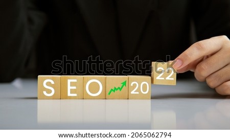 SEO, Search Engine Optimization 2022, Hand holding wooden block represents growing business goals, Ranking traffic website internet business technology concept.