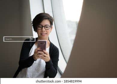 SEO Search Engine Optimization concept. Portrait of a beautiful middle-aged asian business woman texting Keyword on her smartphone. Smart search, Artificial intelligence, Modern marketing Tools. - Shutterstock ID 1854819994